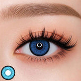 EOS Dolly Eye Blue colored contact lens worn on eye — natural brown tone, FDA 510(k) cleared