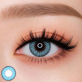 EOS Fairy Blue colored contact lens worn on eye — baby blue tone, FDA 510(k) cleared