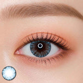 EOS Ice Blue colored contact lens worn on eye — natural brown tone, FDA 510(k) cleared