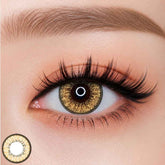 EOS New Adult Brown colored contact lens worn on eye —vivid yellow tone, FDA 510(k) cleared