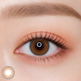 EOS poesie cacao colored contact lens worn on eye — natural brown tone, FDA 510(k) cleared